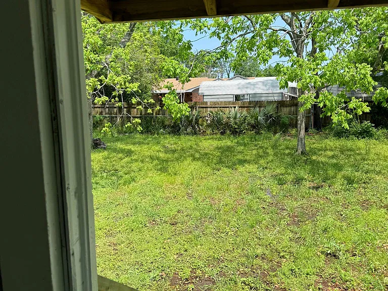 Partially fenced back yard very private.