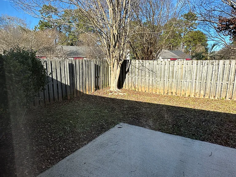 Privacy-fenced, totally enclosed backyard with side gate access and living room access through sliding glass door.