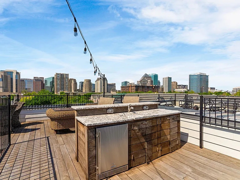 Luxury outdoor living meets urban convenience with a private rooftop bar and lounge.