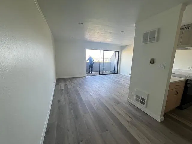 Large living space with luxury vinyl plank with foam backing throughout... looks like hardwood but without the noise, to meet homeowner association requirements.