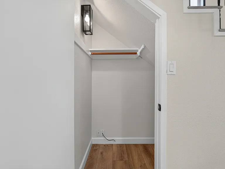 Downstairs under stair storage closet.