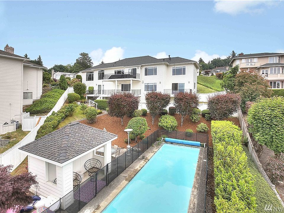 Fully fenced backyard features an in-ground heated lap pool with solar cover, pool fence and shed for equipment.