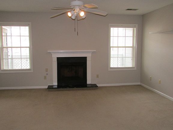The living room is quite large, full of natural light, and f