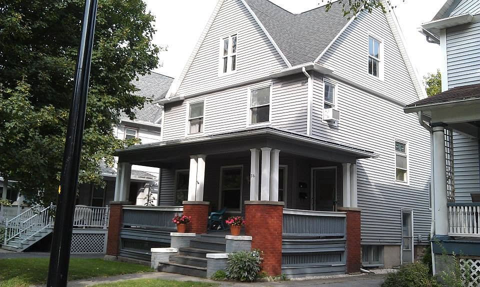 Common front porch, long driveway with off-street parking, fenced backyard.