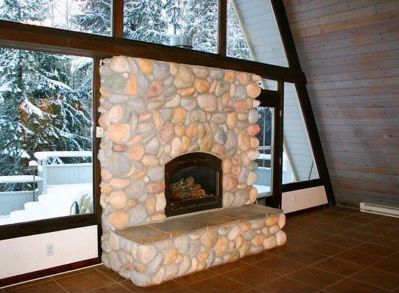 Focal Point of the open Living Space-Wonderful River Rock Fireplace with propane insert that will he