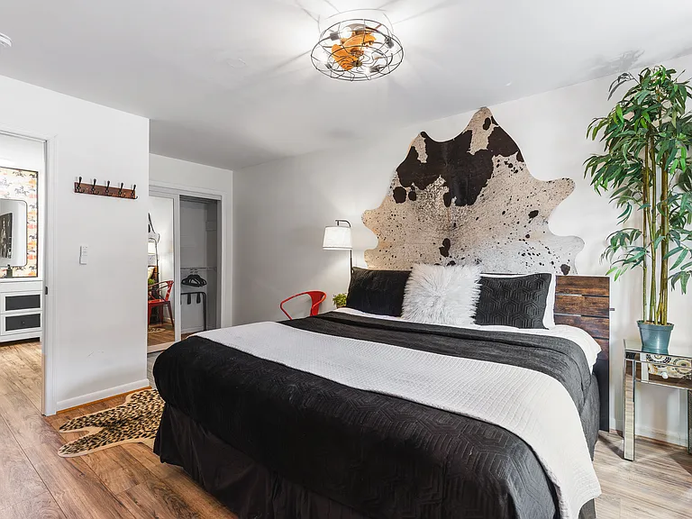 Comfortable King bed in the bedroom. Includes a smart TV, desk to get ready at, dresser and a closet to store your items in.