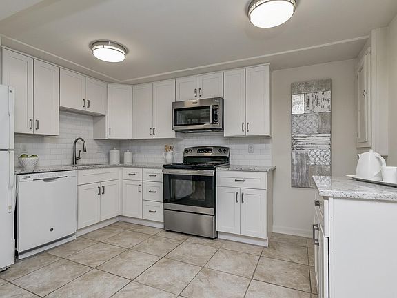 Open plan kitchen with white granite counters