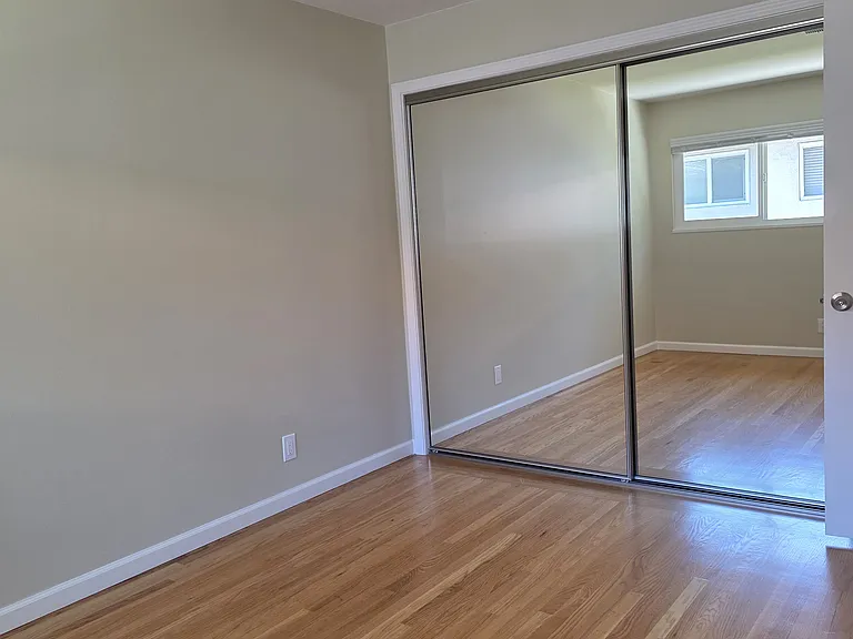2nd bedroom facing the closets. Standing in front of the windows.