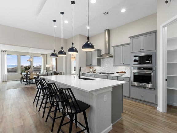 Staggered cabinets, designer pendant lights, and built-in stainless-steel appliances show off the Pa