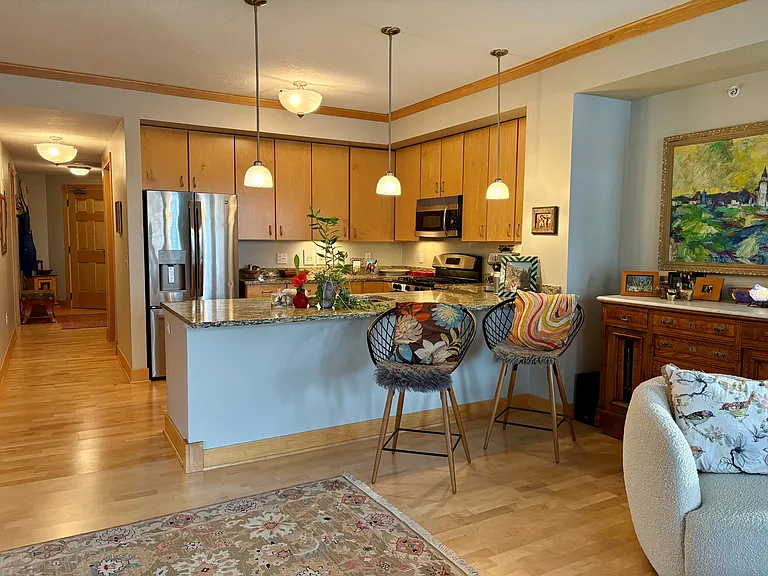 Kitchen area with main door beyond hallway.