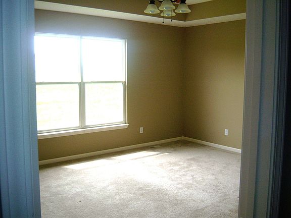 Private master suite with walk in closet and vaulted ceilings.