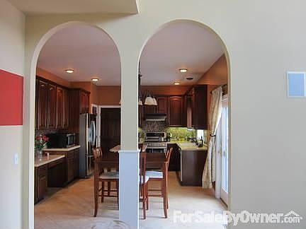 Arched doors leading to Kitchen