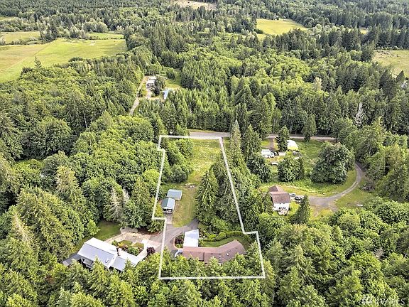 Gorgeous living room with wood-wrapped ceiling leading to a cupola skylight. That's a wood-burning fireplace insert, too. 
