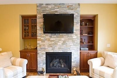 Stacked Stone Fireplace With Built-Ins