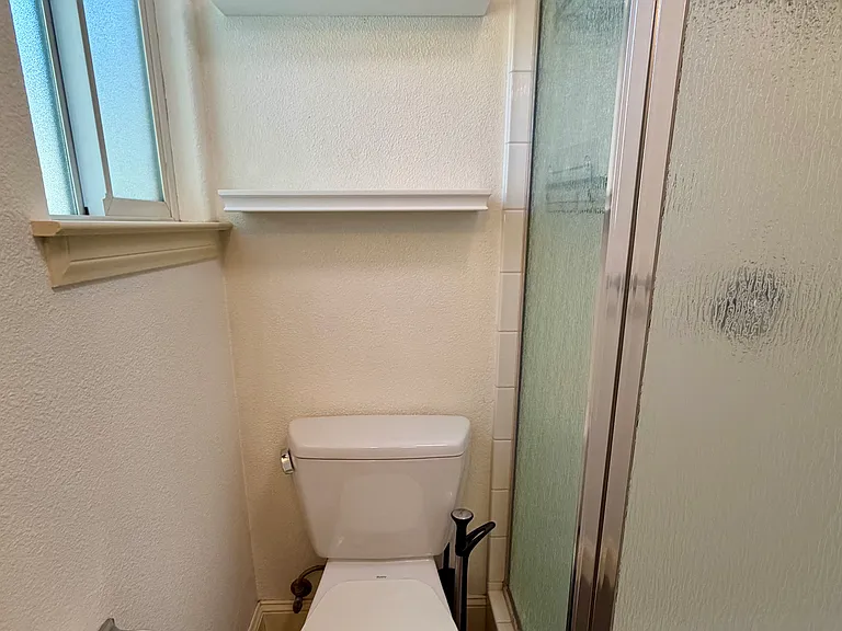toilet location next to shower.