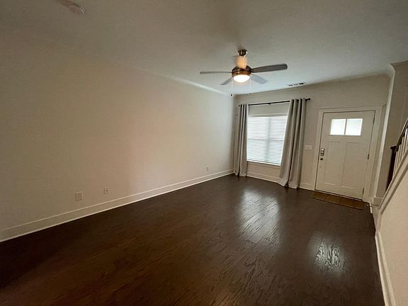 Front door and window. Stairs lead to upstairs bedrooms and attached baths