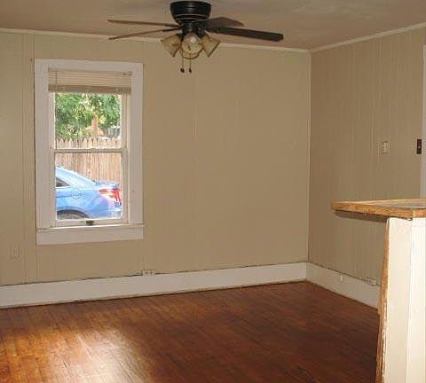 Living room with hardwood floors and lots of windows