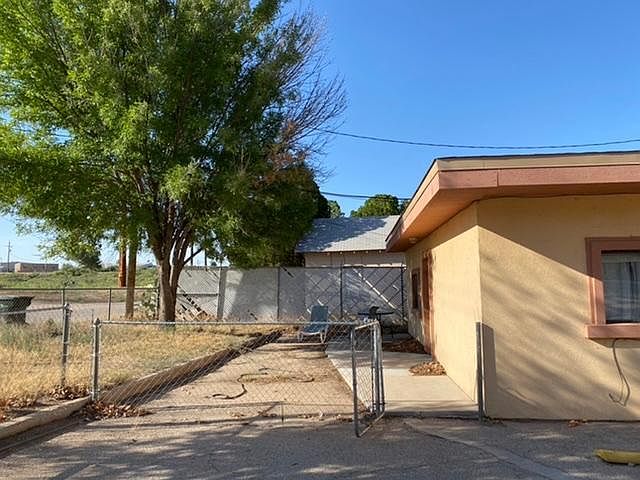 Fenced in yard with parking to the right.