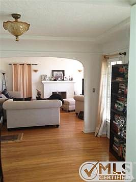 Entry/foyer towards Living Room. Original arches, lath and plaster, picture rail.