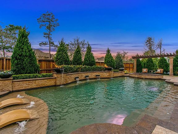 The beautiful pergola adds just the right touch complementing the cantera stone coping of the pool.