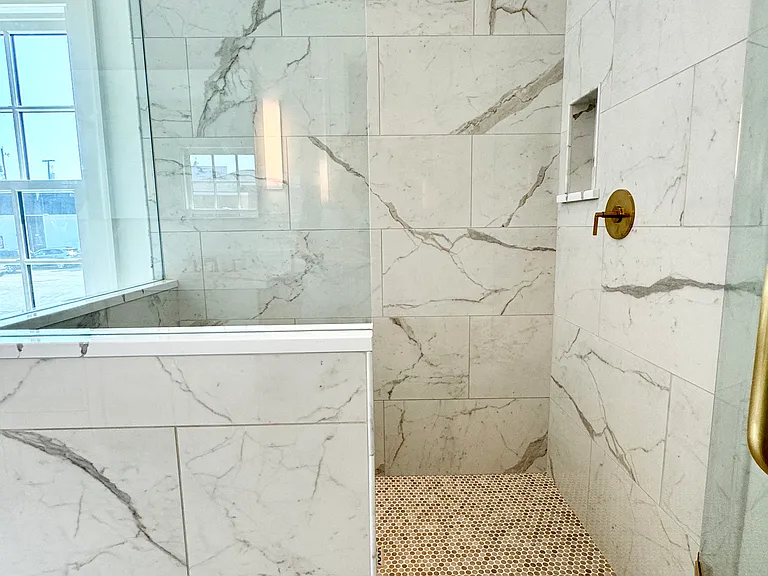 Master bathroom with walk-in shower and front-load washer/dryer