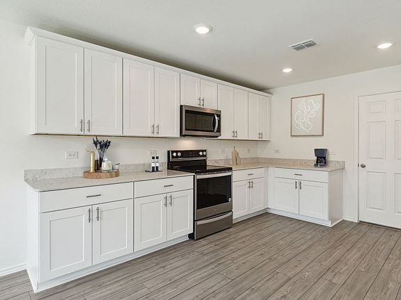 Roomy kitchen designed for functionality and comfort, with plenty of workspace model representatio