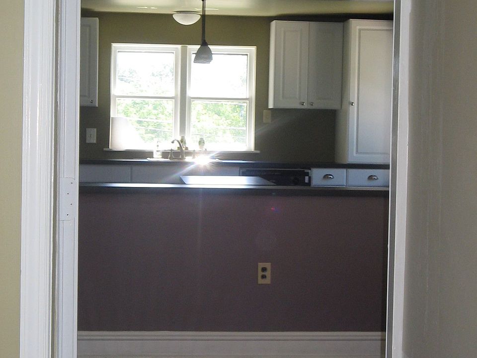 view from great room through dining room into kitchen