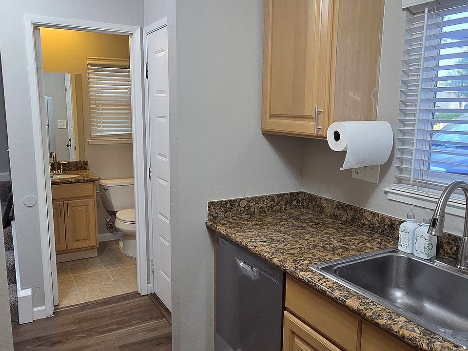 Galley Style Kitchen with new Dishwasher and Range, featuring maple cabinetry and granite countertops