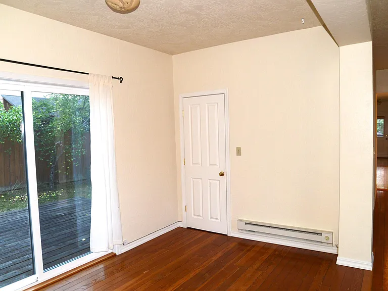 Deck off living room, coat closet, hallway to bedrooms and kitchen. Front door is opposite the coat closet, but more centered on the wall - not in the corner.