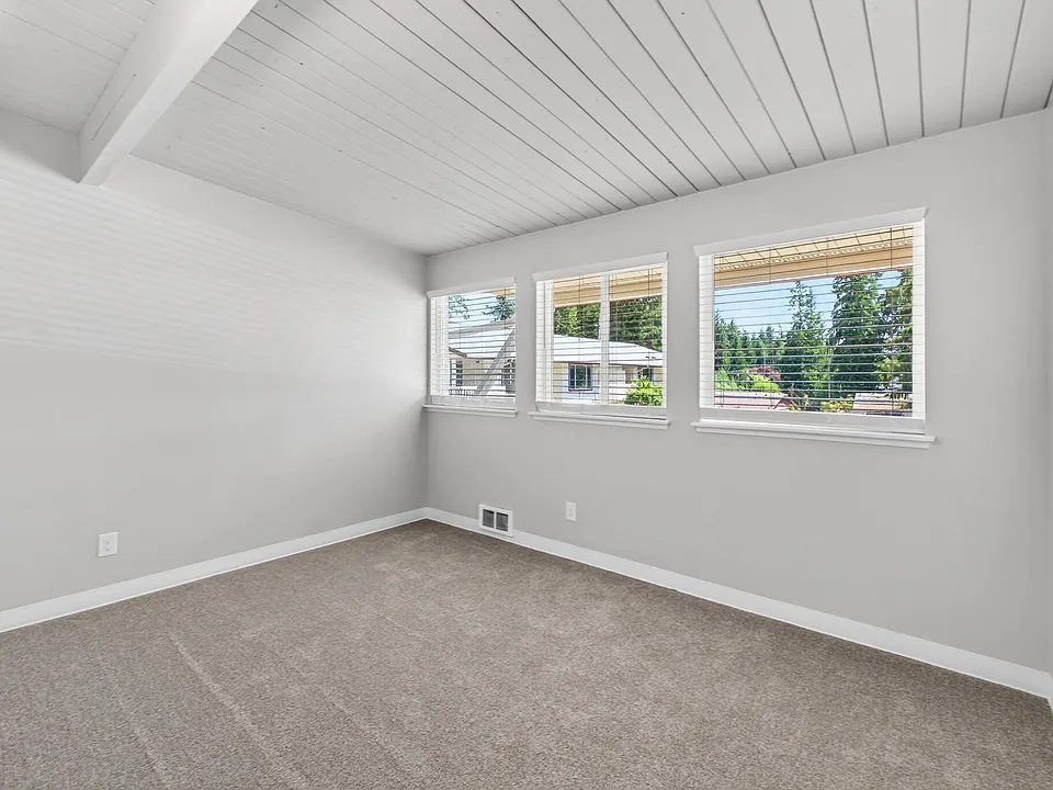 Carpeted bedroom with plenty of natural light
