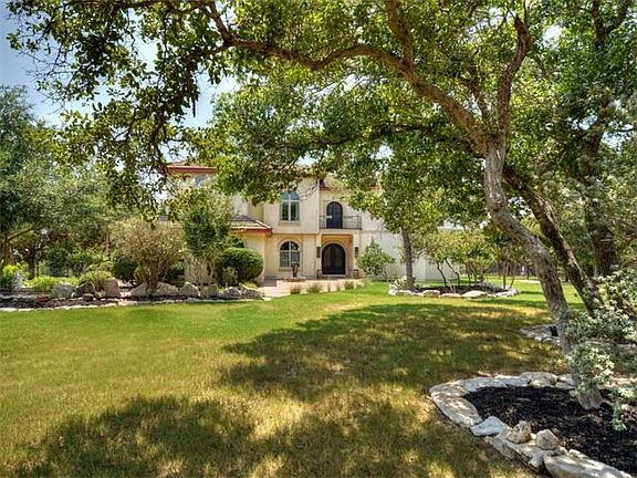 Spacious Tiled Entry features a Relaxing Water Feature and a Lovely Wrought Iron Clad Balcony!