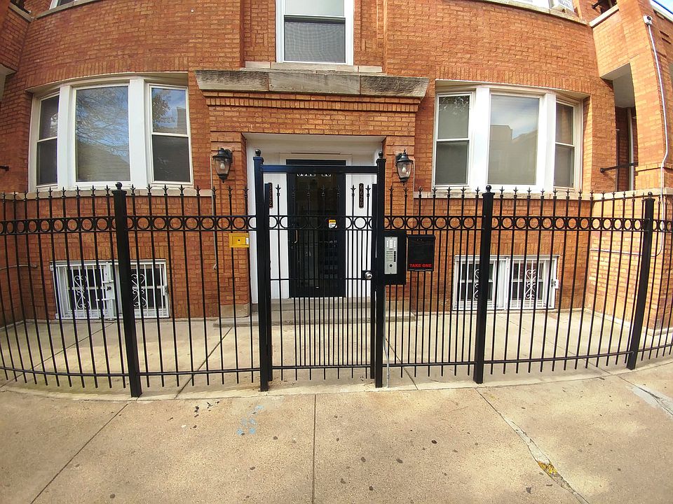 Closeup of front door. Each apartment has a working intercom buzzer.