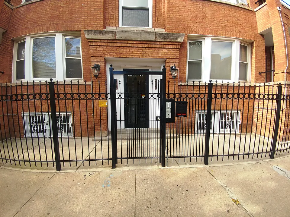 Closeup of front door. Each apartment has a working intercom buzzer.