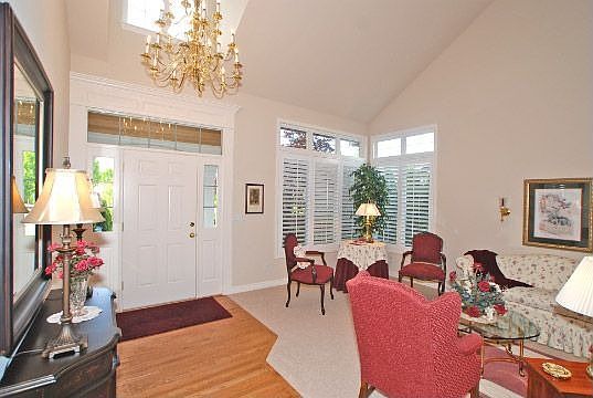 Immaculate formal living room with vaulted ceilings.