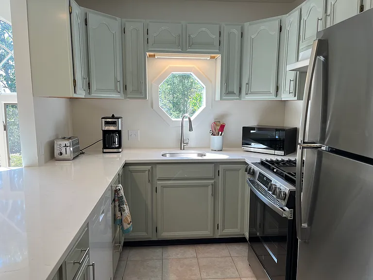 Newly updated and fully equipped kitchen includes quartz countertop and new stainless steel gas stove, refrigerator, exhaust fan and sink/faucet. Also included is a dishwasher, microwave, coffee maker, french press, toaster and more .