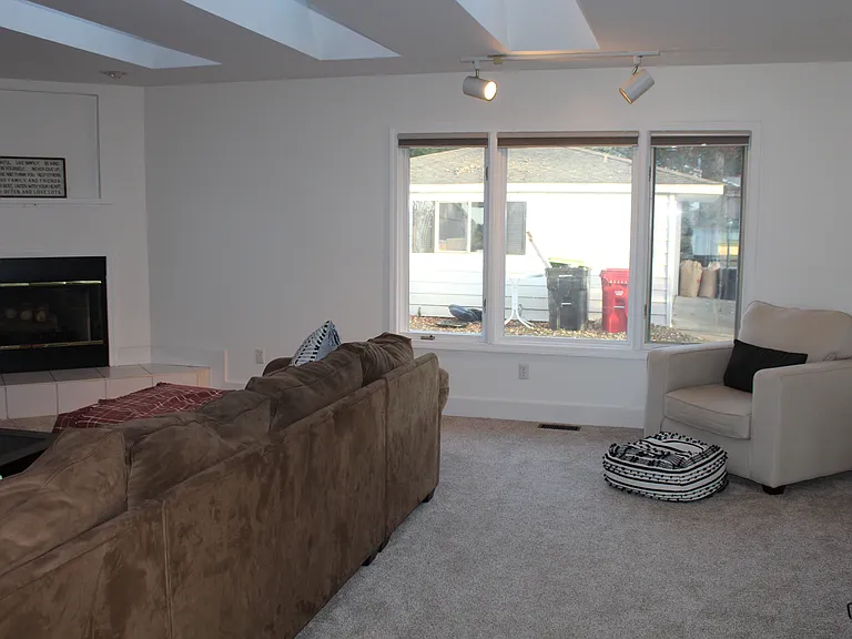 Family room with tv, couch, chair and fireplace