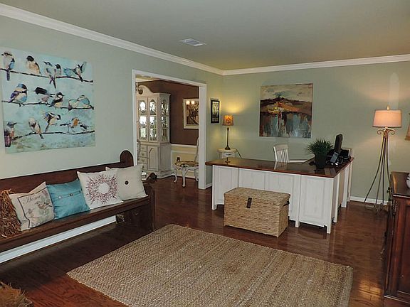 This cheerful living room was used as a study and has two windows that look out into the courtyard.