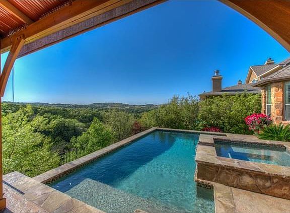 The home overlooks a dedicated greenbelt with a series of hiking trails.