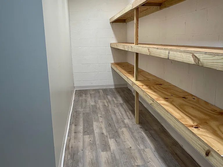 Extra storage room in basement with built in shelves