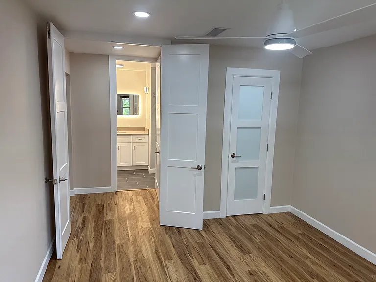 Bedroom looking toward closet door and bathroom