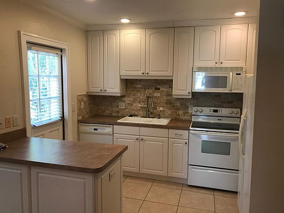 Island kitchen with access door to private driveway