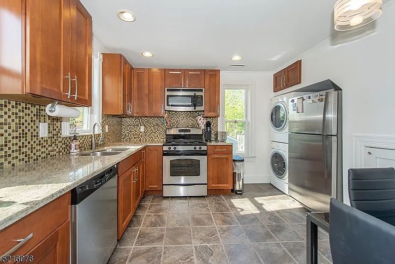 Updated kitchen with stainless steel appliances, conveniently located washer/dryer.