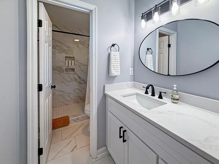 Upstairs Guest Bathroom with walk-in marble shower, large vanity space