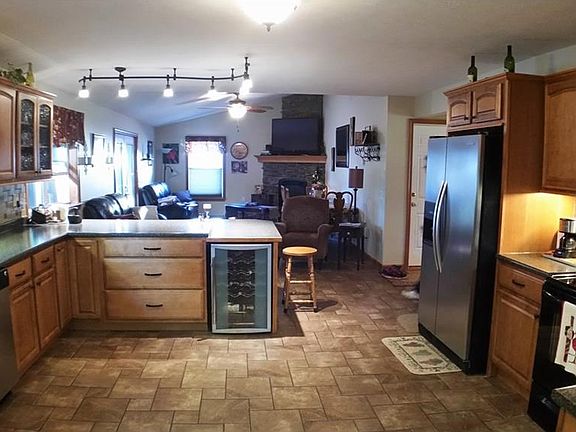 View of kitchen/great room combination. Wine cooler under peninsula breakfast bar.