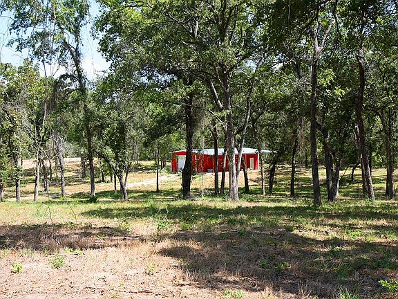Beautiful wooded area surrounding barn.