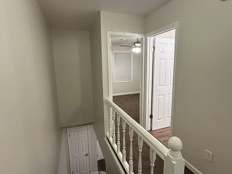 View from top of stairs. Coat closet at bottom of stairs.