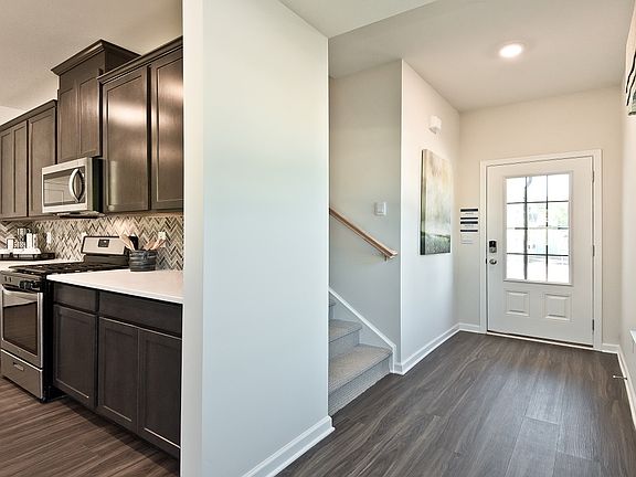 Foyer leads to open-concept living area.
