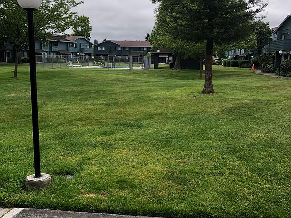 Front of unit looks onto large grassy area and pool.