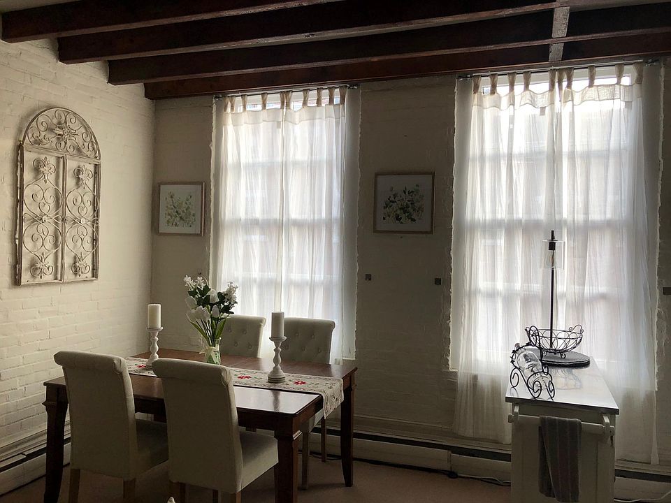 floor to ceiling windows with a view of beautiful, tree-lined Cameron Street with charming buildings all around