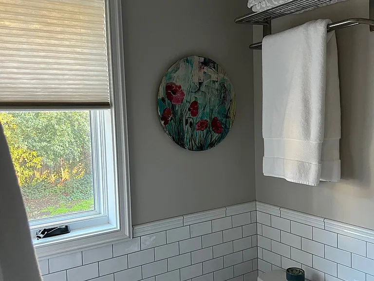Partial bathroom view with street-facing window.